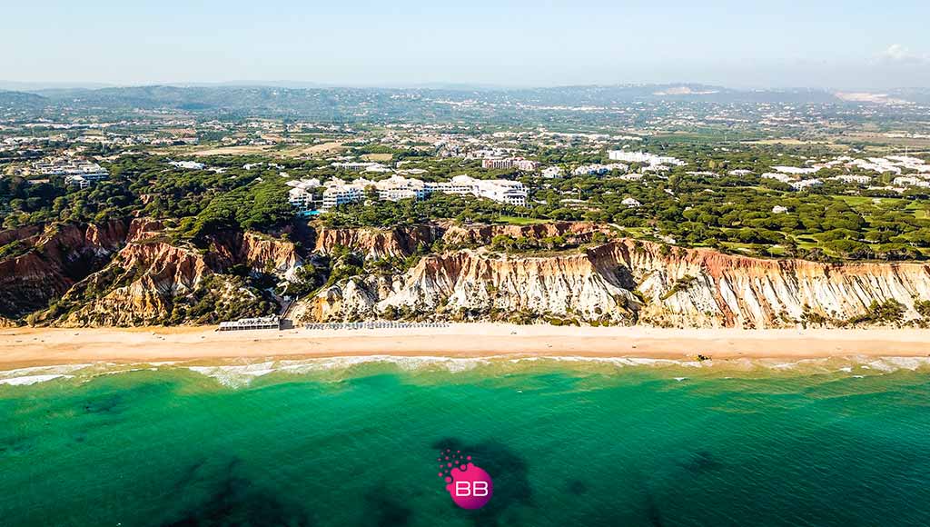 Aerial photos of Pine Cliffs Resort|People playing golf at an iconic hole in Pine Cliffs' golf course||A person having a massage on the terrace of the Serenity Spa|