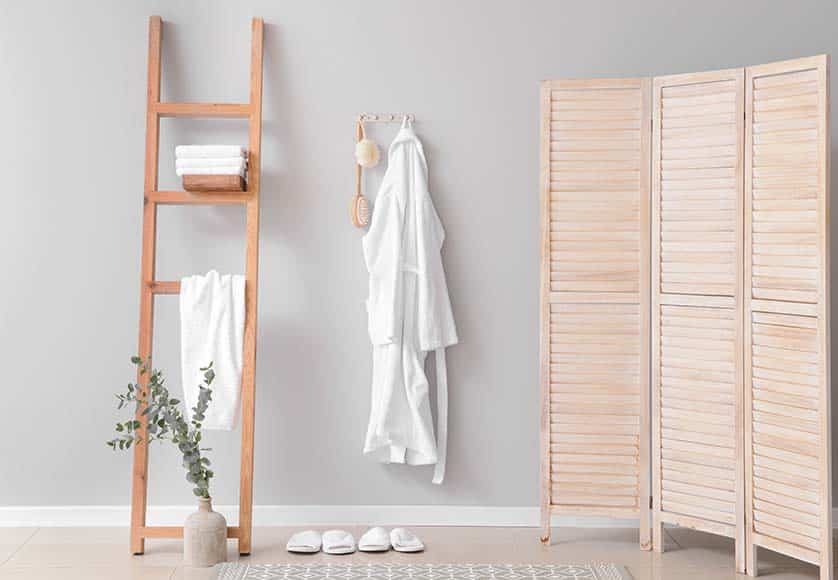 Clean bathrobe hanging on wall in room