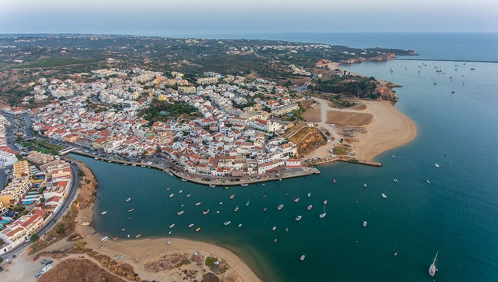 Aerial. Ferragudo at sunset shooting from the sky with drone. Portimao|Bougainvilleas are a typical feature of Ferragudo - RTA|Casa 103 panorama, Ferragudo - Photo Marlene Uldschmidt|Ferragudu's Terrace|Forte de São João do Arade - pexels-micheile-oliviestrauss|Pintadinho beach - Photo Algarve Tourism|Quaint and traditional. Photo: ewan-bullock/Unsplash|Seafood at Ferragudu's Terrace|Casa 103 panorama, Ferragudo. Photo Marlene Uldschmidt