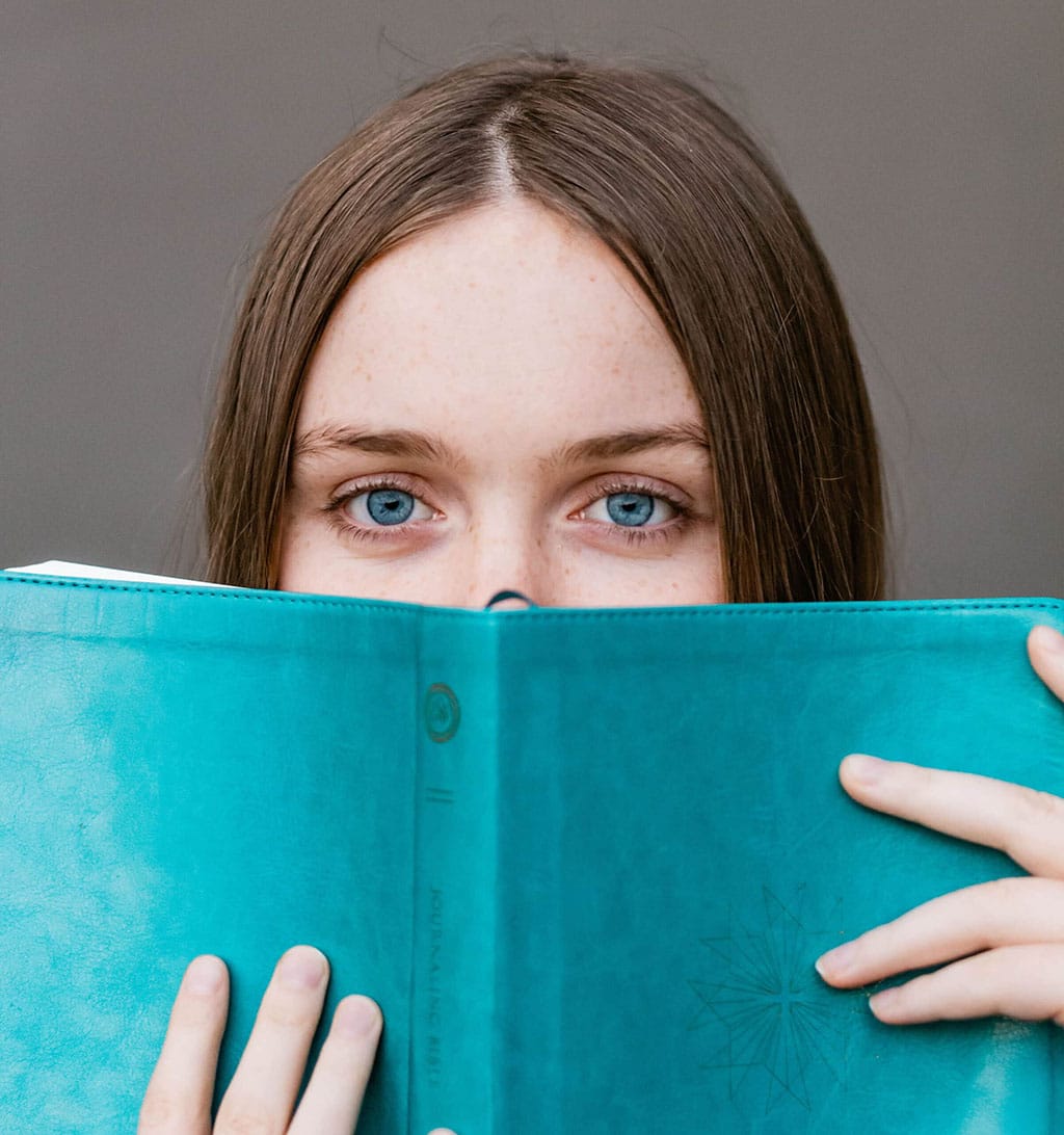 woman holding a book|Magical Christmas Book Fair