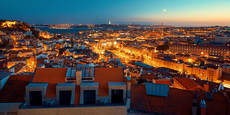 Photo of Lisbon at night-time|beach|Photo of Faro's marina in the Algarve, the region where Sovereign has its Portugal office|beach in Algarve