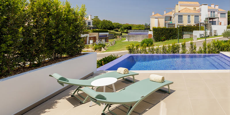 Photo taken from one of the terraces of a Golf Residence in Vale do Lobo to highlight these properties contemporary design|Photo of the living room at one of Vale do Lobo's Golf Residences|Photo of a bedroom at one of Vale do Lobo's Golf Residences||