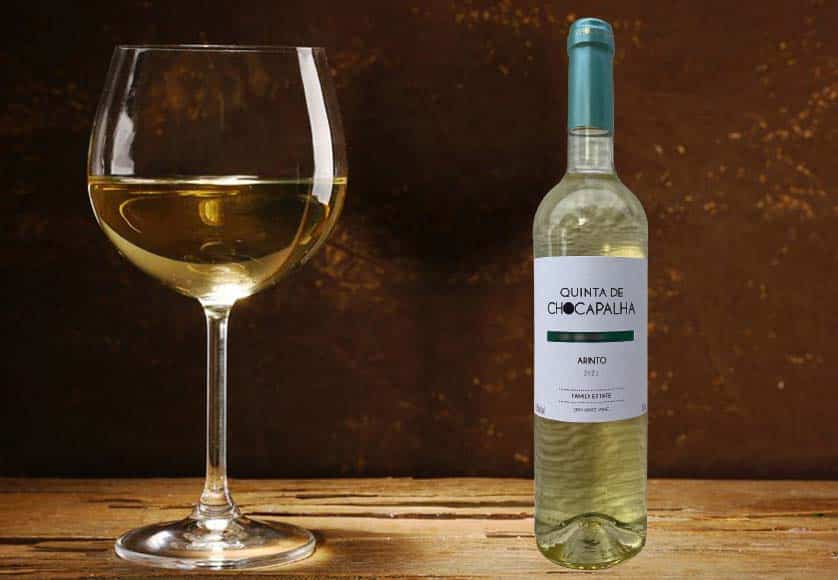 Goblet of white wine on wooden table on wooden wall background. Fotalia