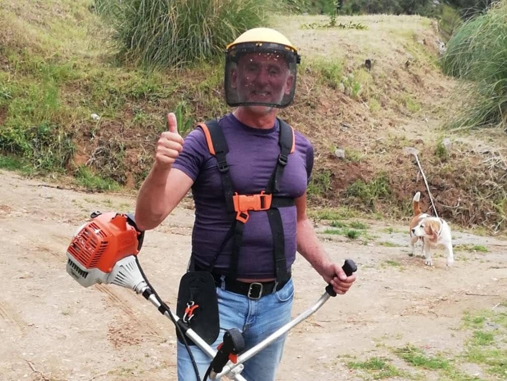 Derek with a strimmer, Beagle Ben wisely keeping clear
