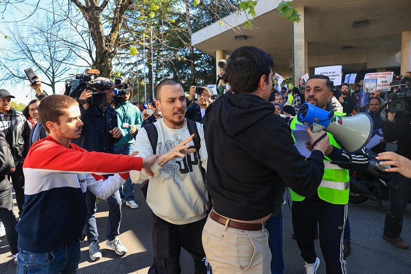 Police remove anti-immigration activist from immigrant protest outside AIMA offices