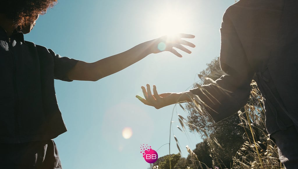 Two hands approaching in the sun in one of Vilamoura's outside spaces