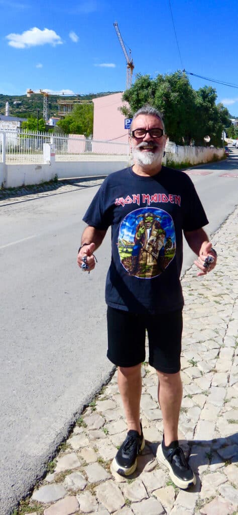 Carlos, secretary of village council, biker guy and proprietor of Sooner or Later. Note the crane over his shoulder.