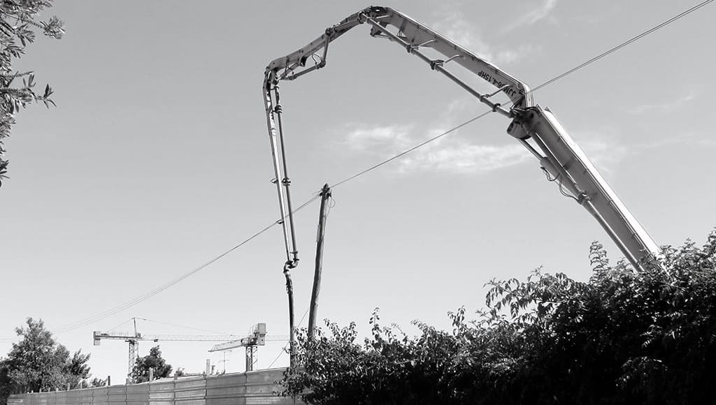 Three cranes at three separate building sites in Santa Bárbara de Nexe
