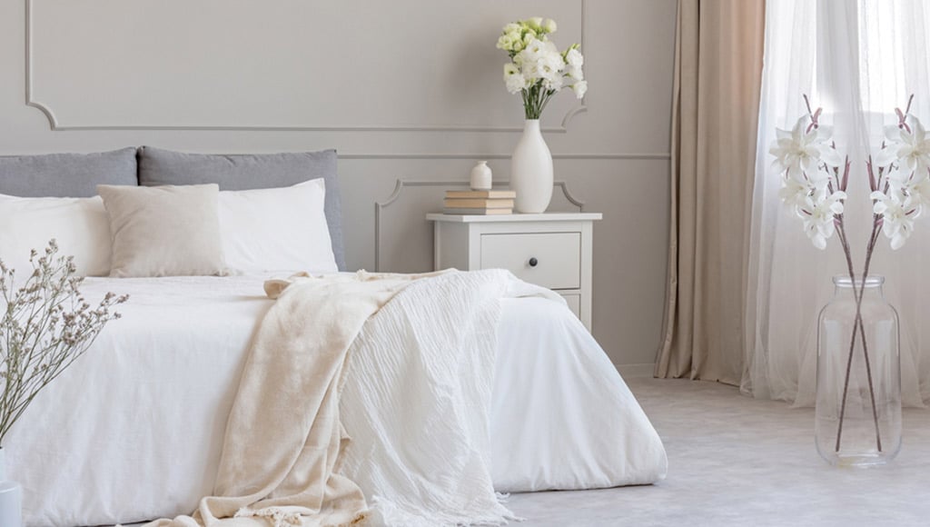 Photo of a bedroom with quality linen on the bed