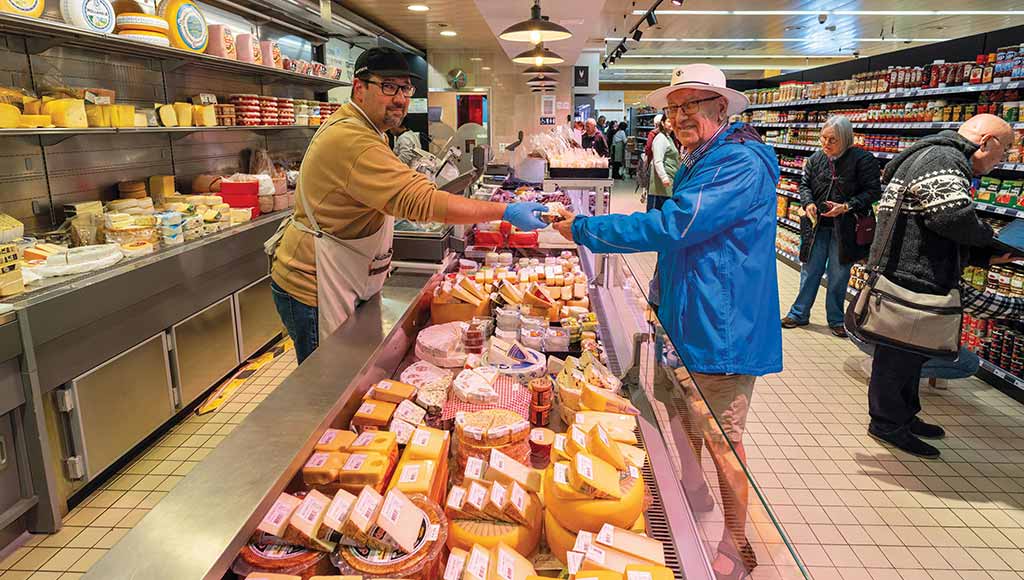 A client receiving their goods at the cheeses' counter in Baptista Supermarket