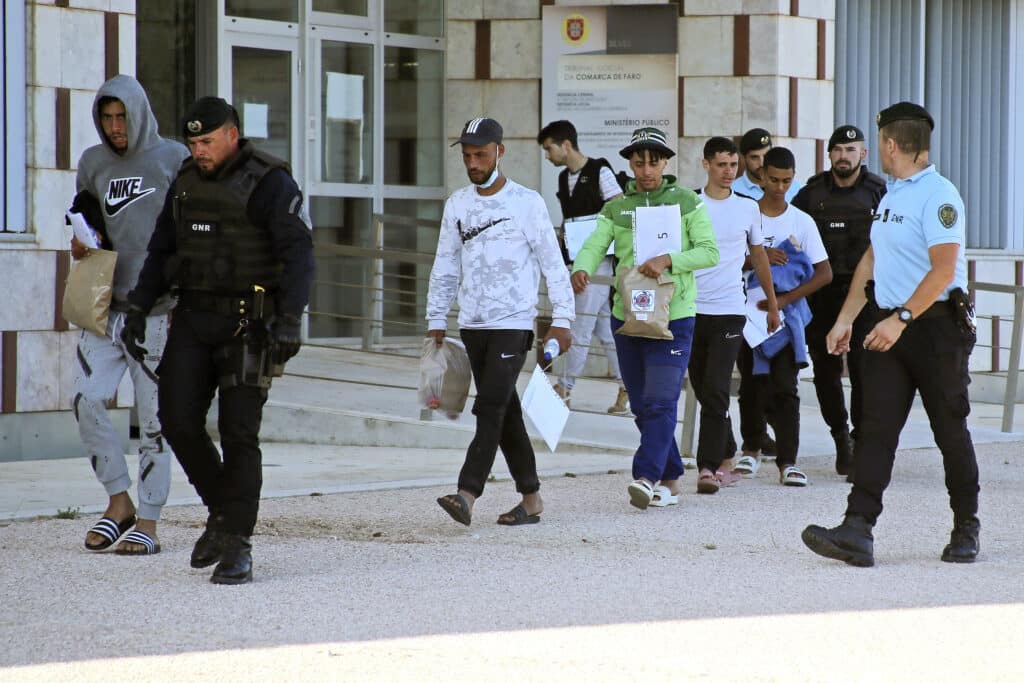 Migrants being escorted by GNR officers outside Silves Court on August 9 - Photo: João Matos/Lusa