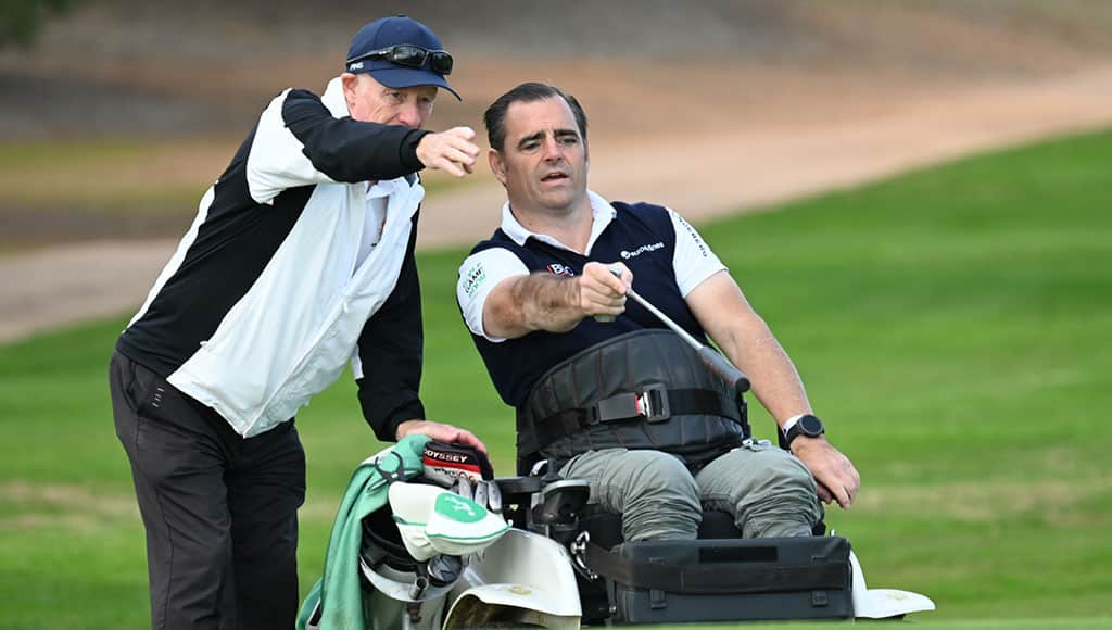 Volunteer John Scott and Fernando line up a putt
