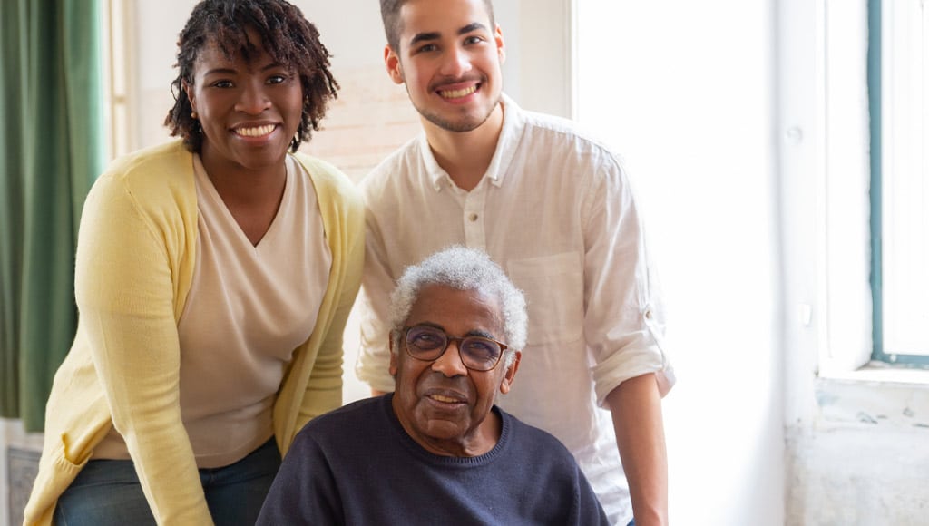 An old man with his daughter and a professional of live-in care