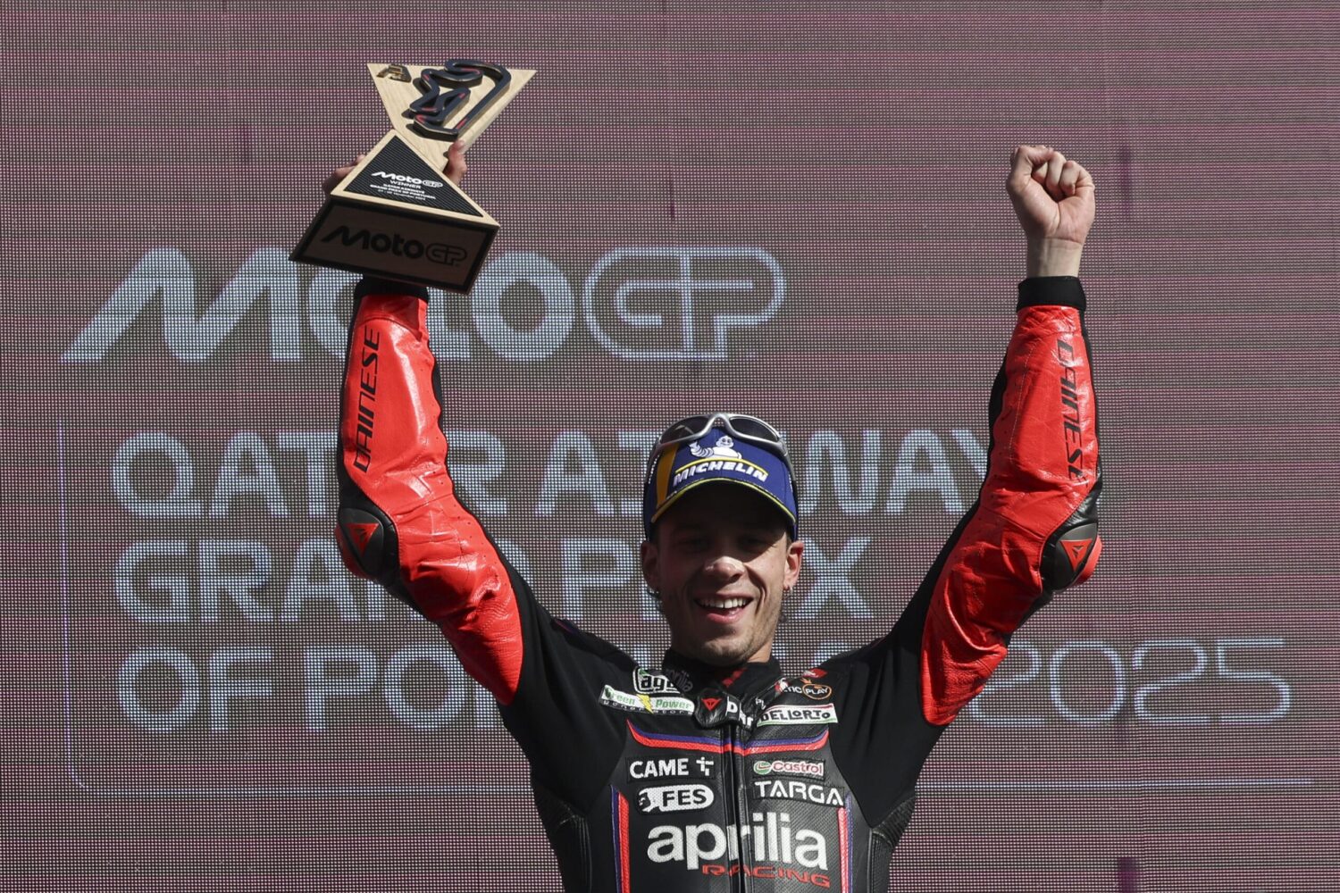 Italian rider of Aprilia Racing Marco Bezzecchi celebrates during the podium ceremony of the Moto GP race for the Motorcycling Grand Prix of Portugal, in Portimao, Portugal, 09 November 2025. JOSE SENA GOULAO/LUSA