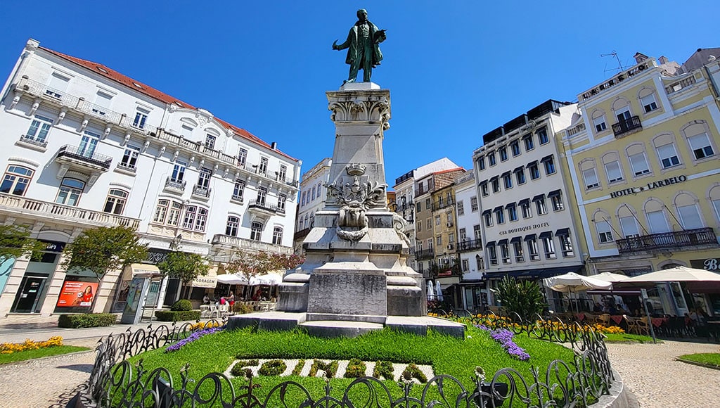 Coimbra’s central square - History gathers around the monument, with cafés and bright balconies framing the city’s heart.