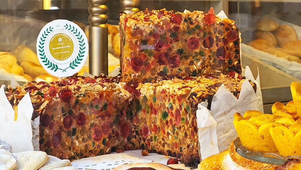 Sweets behind the glass - A bakery window stacked with fruit cake and pastries; tradition shown in every vivid slice.