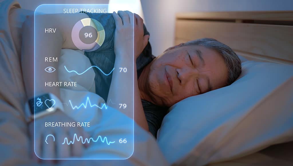 Asia elderly man wear smartwatch for sleeping tracking on arm IoT tech collect data app device relax body on cozy bed in future life at home
