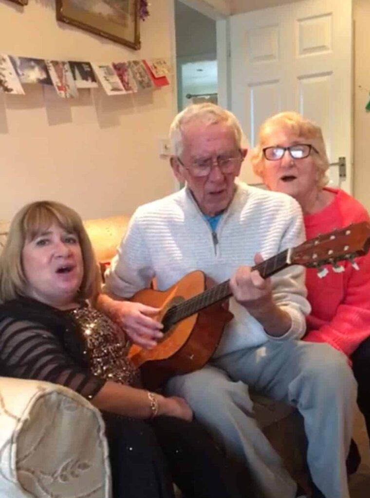 Carole, Dad and Mum singing Christmas songs