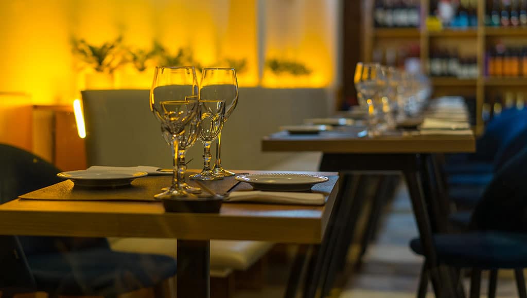A calm table waiting in Braga: Soft light, empty glasses, and a sense of unhurried welcome. This is how many journeys here begin.