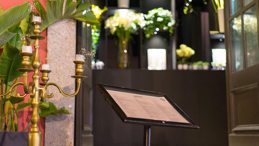A restaurant doorway dressed for evening: Candles, flowers, and a quiet glow. A hint of the elegance hiding inside many Portugal streets.