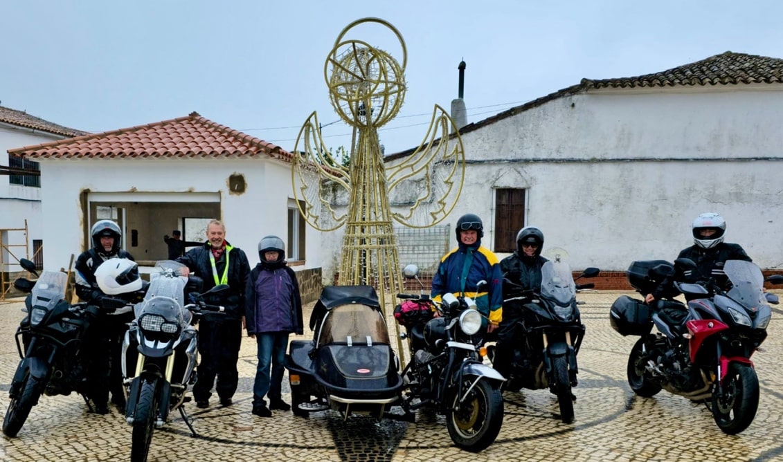 Six bikers in full rain gear in the Sierra de Aracena y Picos de Aroche Natural Park in Andalusia.
