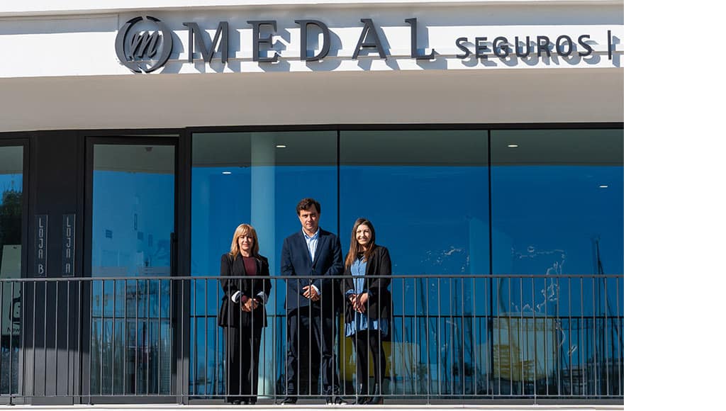 Three members of MEDAL's team on the balcony of their new office in Lagos
