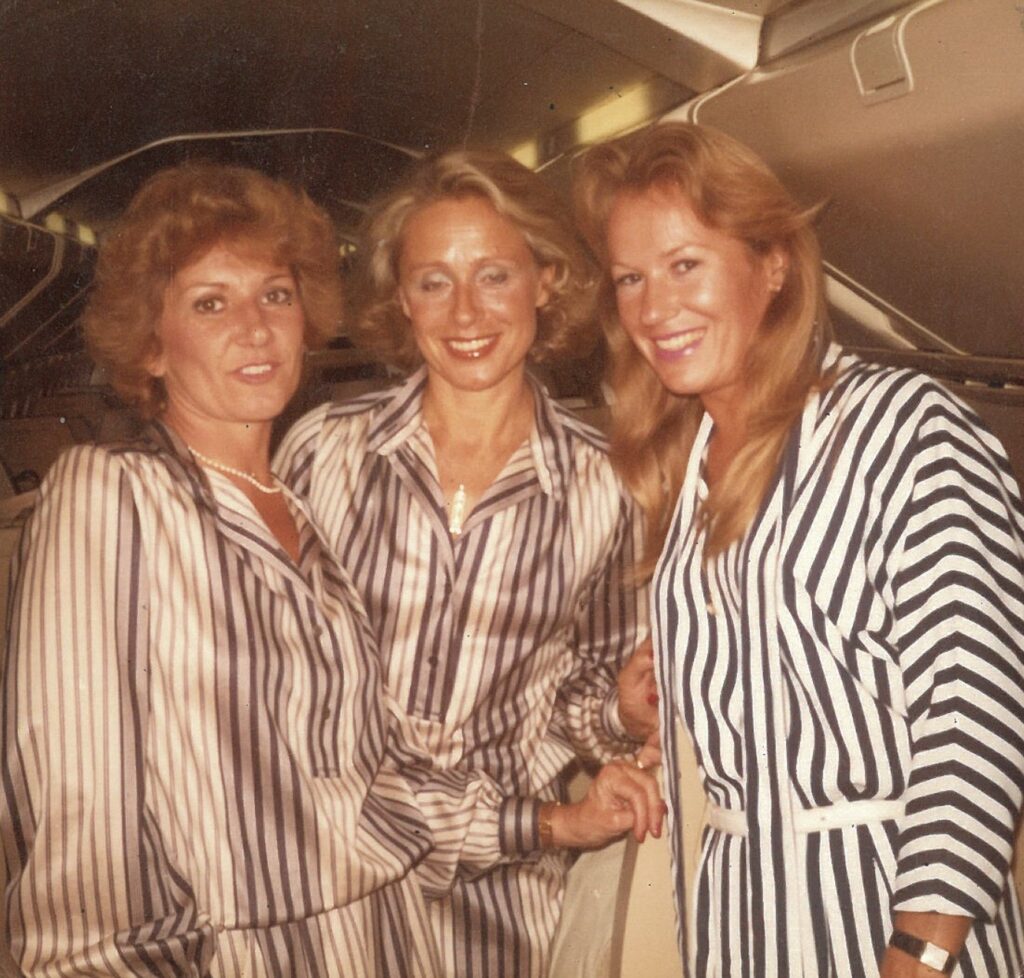 Two Concorde stewardesses in Jean Patou uniforms with Katherine Hallawell, who travelled that day as a passenger