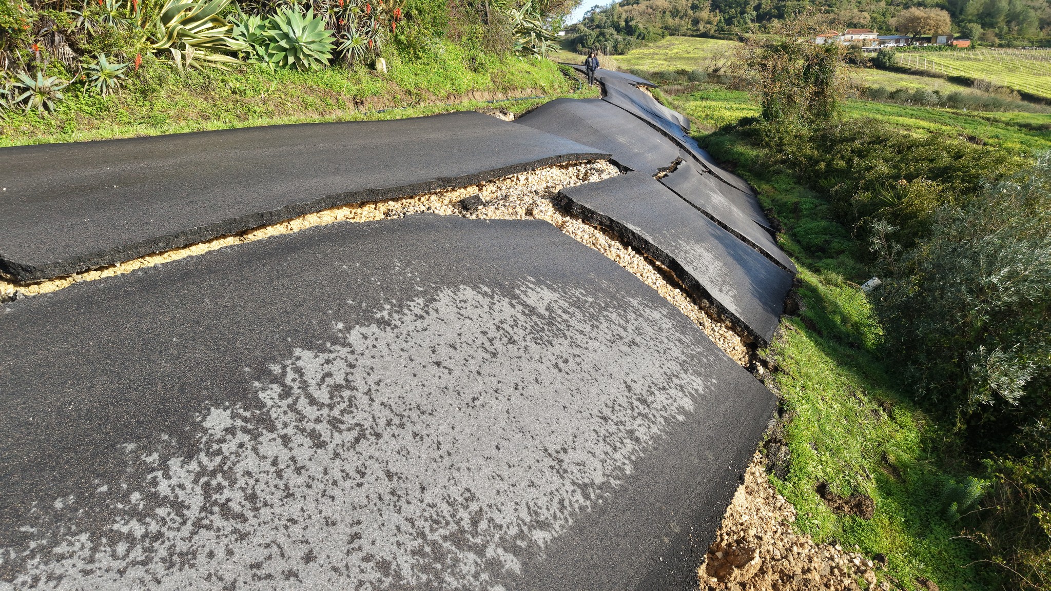 images of damages to roads, like this one in Arruda dos Vinhos, have prompted many to query whether some of the nation's infrastructure has been well constructed from the start.
