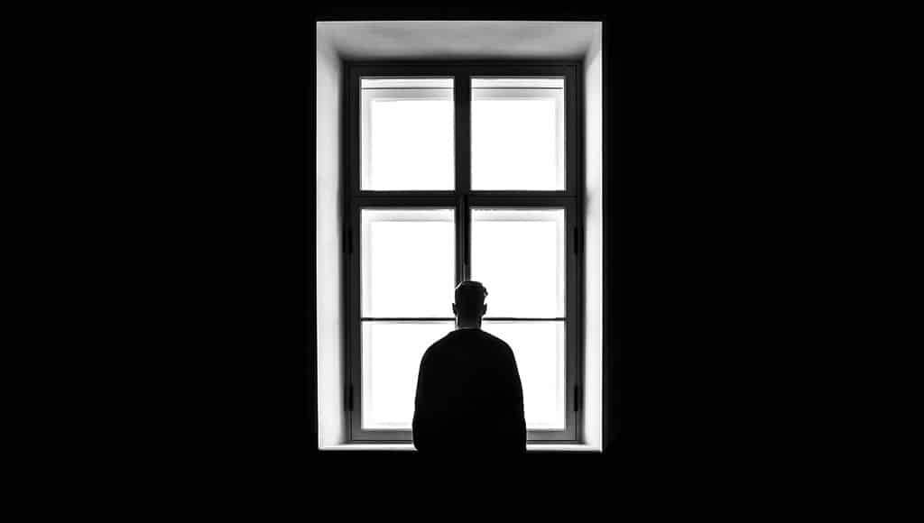 Man at window (Sasha Freemind-unsplash)